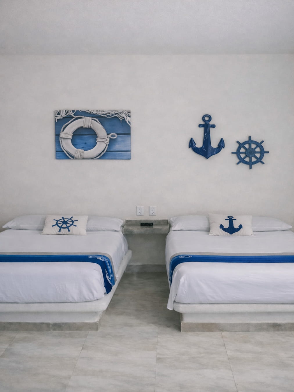 Vista de las dos camas dobles, decoración y buró de la habitación Triple 5 – Casa Tania